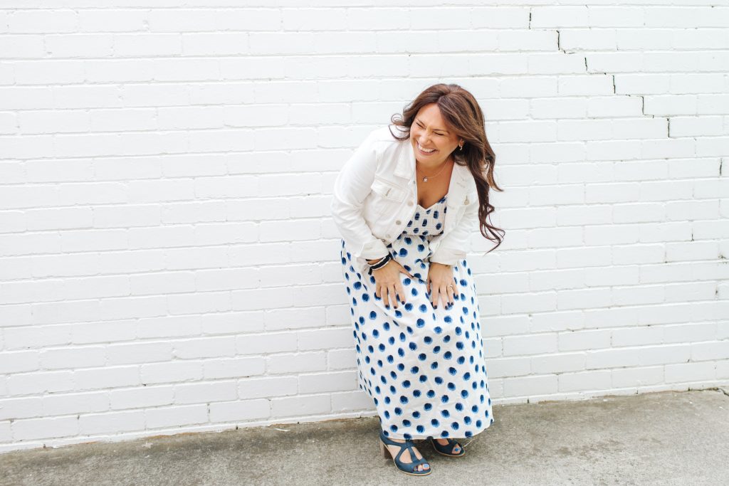 Holly laughing in front of wall